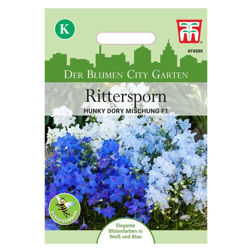 Ein Thompson&Morgan Rittersporn 'Hunky Dory Mix' F1 Samenpaket zeigt weiße und blaue Delphinium grandiflorum Blüten auf einer grün-weißen Verpackung mit deutschem Text und einem Blumenfoto auf der Vorderseite.