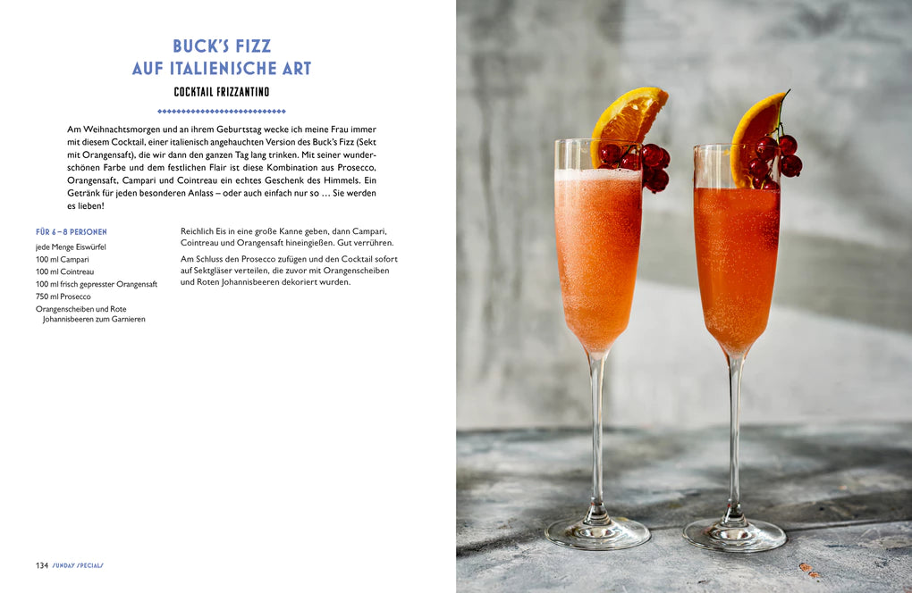 Zwei hohe Gläser mit orangefarbenem Buck's Fizz, inspiriert von Ginos italienischer Küche aus dem Hölker Verlag, sind mit Orangenscheiben und roten Beeren auf einer grauen Fläche garniert, daneben sind Rezeptangaben abgebildet.