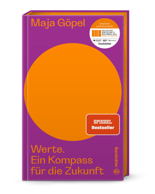 Buchumschlag von "Werte - Ein Kompass für die Zukunft" aus dem Brandstätter Verlag, mit einem großen orangefarbenen Kreis auf violettem Hintergrund, gelber Schrift und zwei Preisaufklebern auf der Vorderseite.