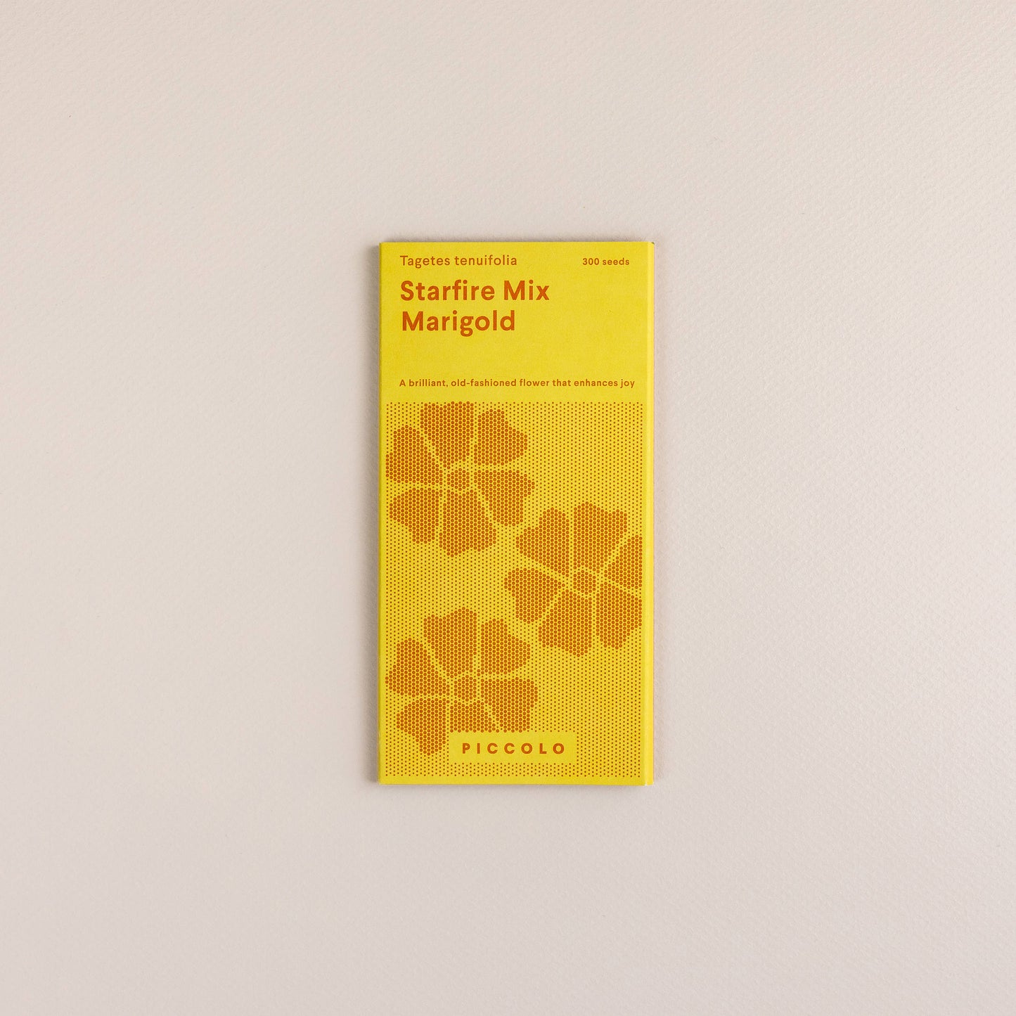 Eine gelbe Packung mit der Aufschrift „Piccolo Seeds – Ringelblume Starfire Mix“ zeigt orangefarbene Ringelblumenillustrationen, beschreibt sie als brillante, altmodische Zierpflanze zur Steigerung der Freude und zeigt unten die Marke Piccolo Seeds.