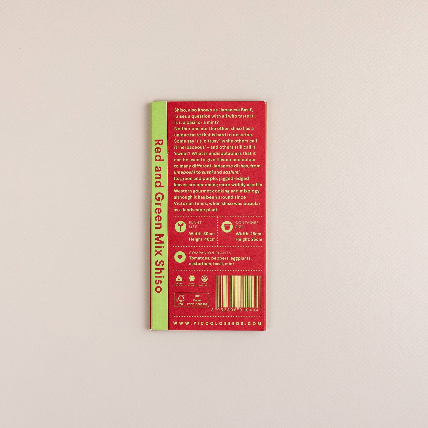 Eine Piccolo Seeds-Packung mit der Aufschrift "Piccolo Seeds - Shiso Rot und Grün Mix" (Rot und Grün Shiso, auch japanisches Basilikum genannt) liegt auf einer strukturierten Oberfläche, mit detaillierten Pflanzanweisungen und einem Strichcode auf der Rückseite.