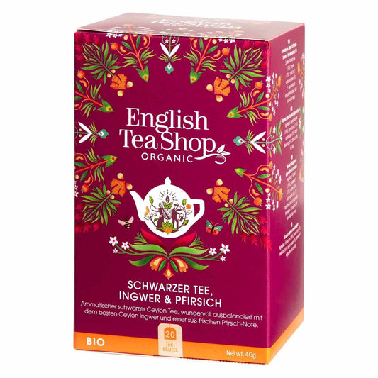 Eine Packung English Tea Shop Schwarzer Tee, Ingwer & Pfirsich, BIO, 20 Beutel. Die tiefrosa Box mit weißer Teekanne und bunten Blumenmotiven informiert auf Deutsch über die hochwertige Schwarzteemischung.