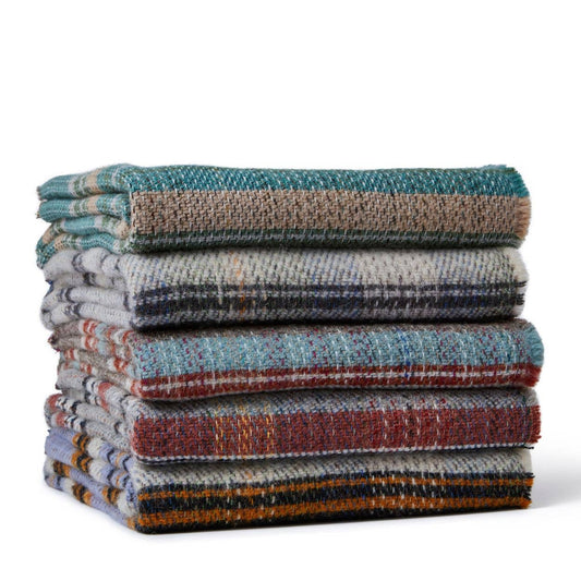 Ein ordentlich gestapelter Stapel von fünf Tweedmill | Zufällige recycelte Wolldecke - Groß - verschiedene Farben von Tweedmill Textiles, mit mehrfarbigen Karomustern im klassischen britischen Stil auf weißem Hintergrund.