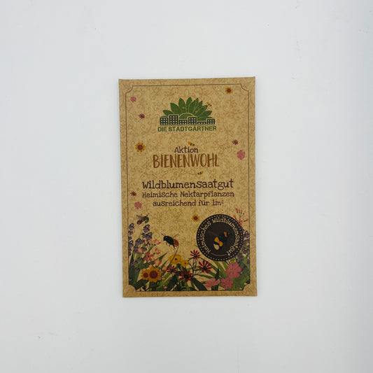 Ein Stadtgärtner Bienenwohl - Wildblumensaatgut-Paket zeigt Wildblumen, Bienen und Waben und wirbt für heimische Nektarpflanzen für Bienen mit genügend Samen, um 1 m² zu säen.