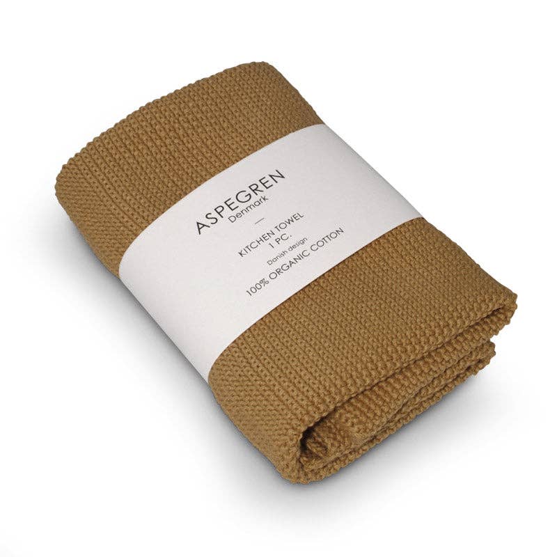 Ein gefaltetes, braunes Küchentuch mit Waffelmuster, umhüllt von einem weißen Etikett mit der Aufschrift Aspegren Denmark - Geschenkset - Melone - 100% Organic Cotton, eine nachhaltige Geschenkidee für die Küche.