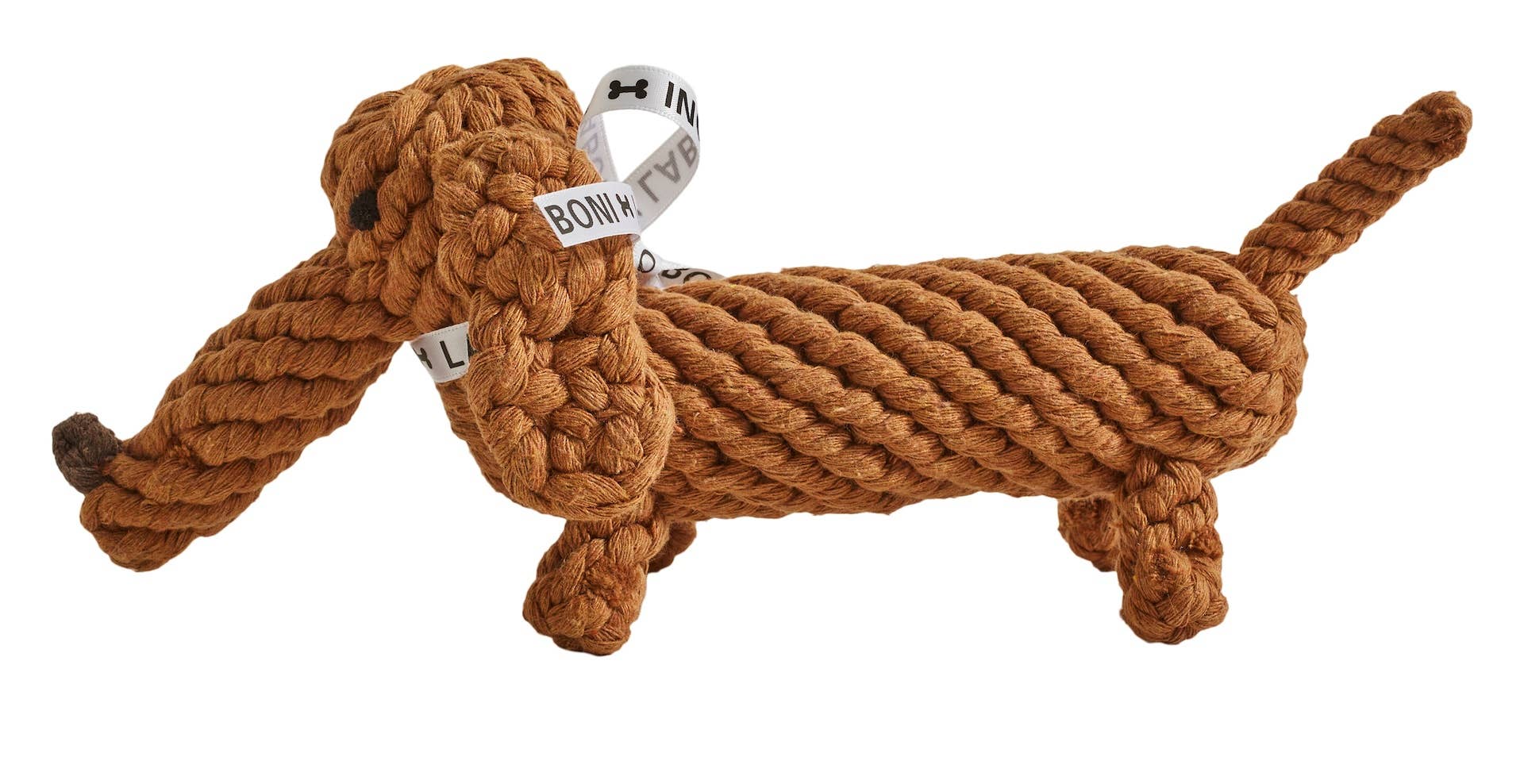 Der Diego Dackel von LABONI ist ein braunes, handgefertigtes Kauspielzeug aus Baumwolle in Form eines Dackels mit langen Ohren, gewelltem Schwanz und einer Schleife am Kopf.