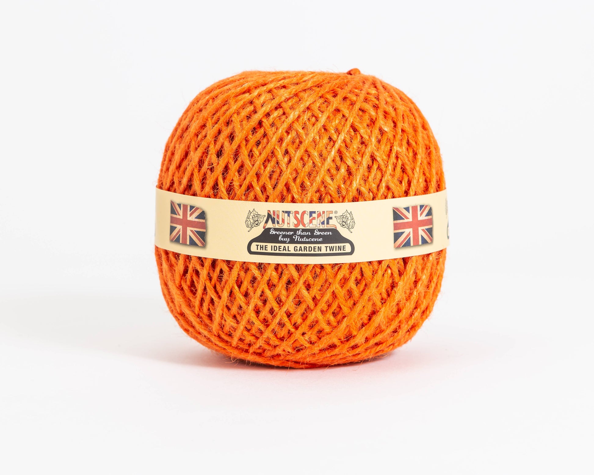 Ein Knäuel aus leuchtend orangefarbener Nutscene Twines Ltd Jute-Schnur aus der Heritage Twine-Reihe, mit beigem Etikett mit britischen Flaggen und Text, präsentiert vor weißem Hintergrund.
