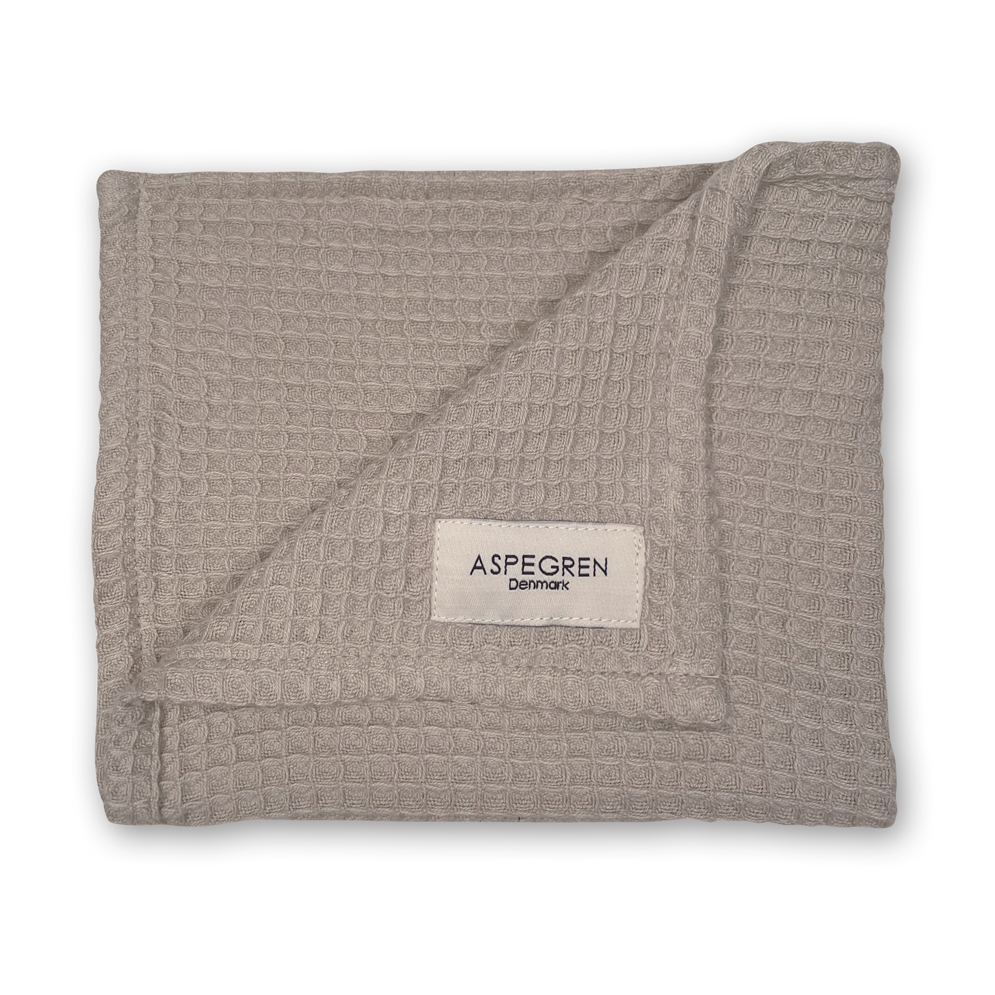 Abgebildet ist ein gefaltetes, hellgraues, umweltfreundliches Geschirrtuch mit Waffelstruktur aus dem Geschenkset „Lemon Grass“ von Aspegren Denmark mit einem sichtbaren Markenetikett an einer Ecke vor einem schwarzen Hintergrund.