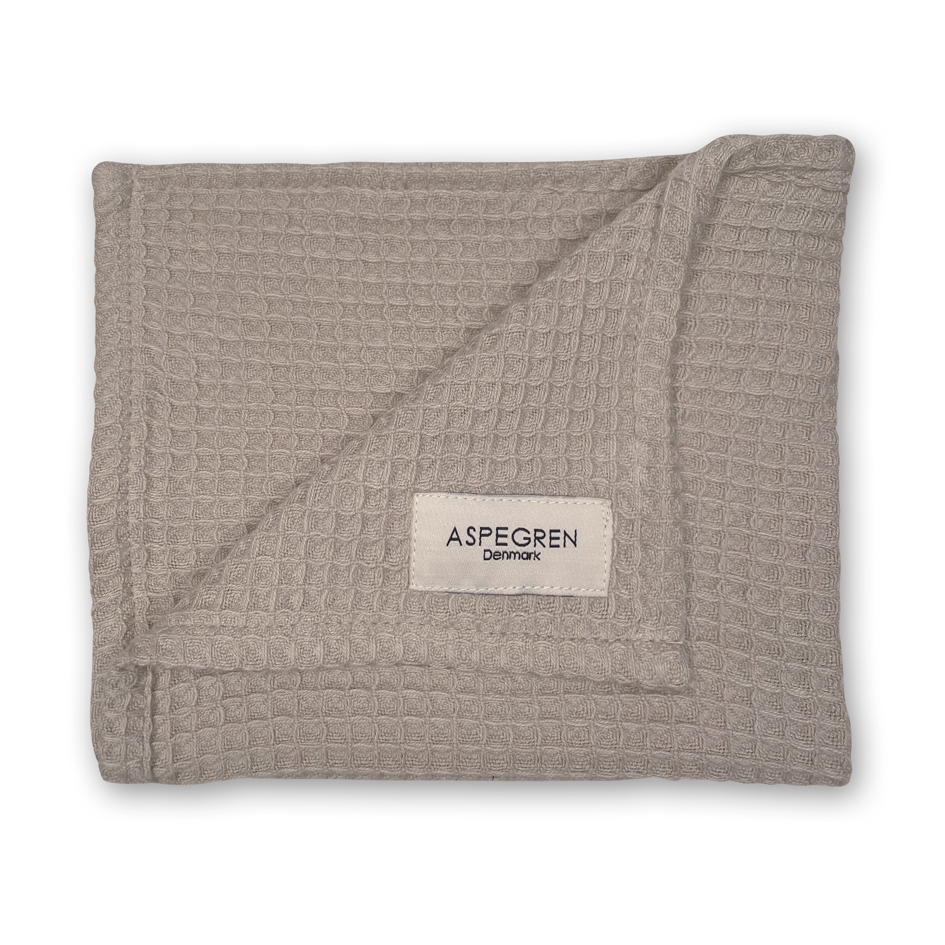 Abgebildet ist ein gefaltetes, hellgraues, umweltfreundliches Geschirrtuch mit Waffelstruktur aus dem Geschenkset „Lemon Grass“ von Aspegren Denmark mit einem sichtbaren Markenetikett an einer Ecke vor einem schwarzen Hintergrund.