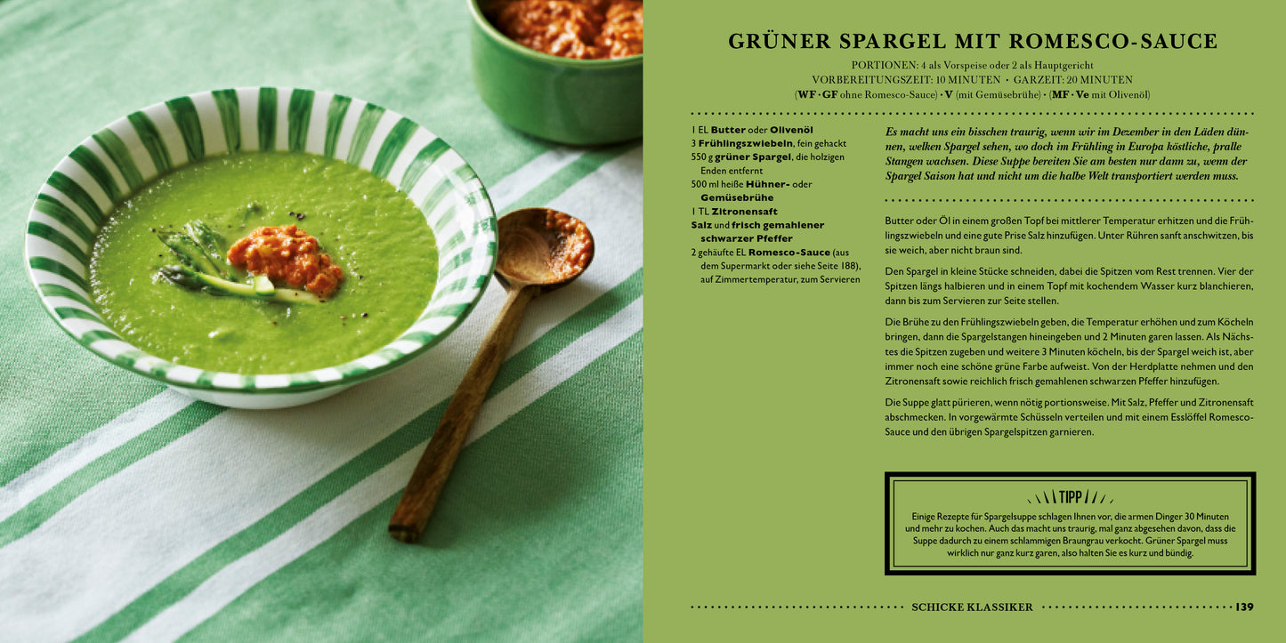 Eine grüne Spargelsuppe aus LEON. Hundert Suppen. aus dem Dumont Verlag wird mit Romesco-Sauce auf einem gestreiften Tuch serviert; zusätzliche Sauce befindet sich in einem Schälchen dahinter. Rechts steht der Rezepttext aus dem Buch.