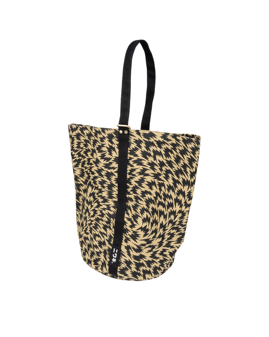 Die Kantan Werkzeugtasche - Eley Kishimoto X Niwaki Flash Kantan Bag von Königliche Gartenakademie zeichnet sich durch ein auffälliges schwarz-beiges Zickzackmuster, robuste schwarze Griffe und einen vertikalen Streifen mit weißen Logos auf der Vorderseite aus.