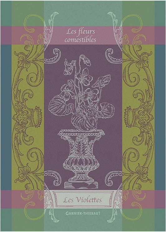 Ein dekorativer Bucheinband, inspiriert von dem Geschirrtuch Garnier Thiebaut "Les Violettes" aus der Königlichen Gartenakademie, mit weißen Veilchen in einer Vase auf lila und grün mit verzierten Goldborten.