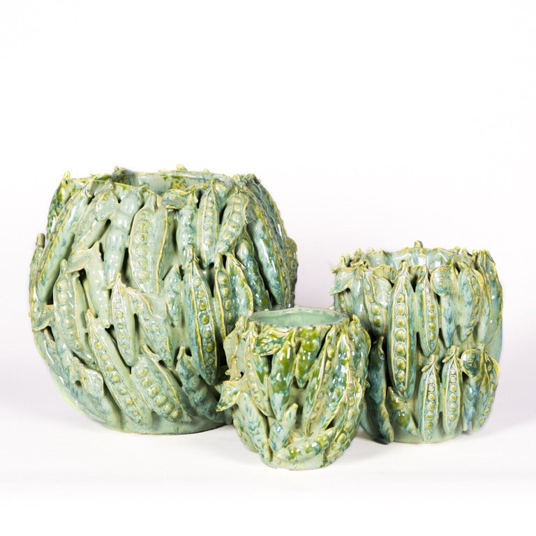 Drei Vasen "Grün mit Schoten" von Des Pots aus Keramik, glänzend grün glasiert, mit erhabenem Erbsenschoten-Design - ein dekoratives Set in unterschiedlichen Größen auf weißem Hintergrund.
