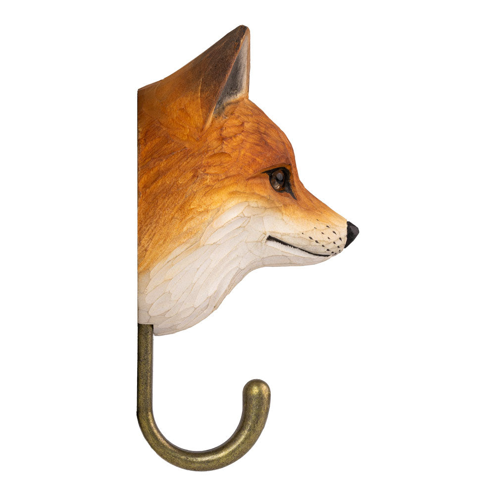 Der handgeschnitzte Holz-Wandhaken "Fuchs" von Wildlife Garden zeigt einen kunstvoll bemalten, orange-weißen Fuchskopf im Profil nach rechts sowie einen eleganten Haken - ideal als dekorativer Kleiderhaken.