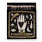 Eine schwarze quadratische Streichholzschachtel von Archivist Gallery, "Schwarzes Wunder", zeigt goldene, weiße und schwarze Motive - eine Hand mit Herz, Sternen, Anhängern, Augen, Mond - und die Worte "MIRACLE" & "LUXURY MATCHES" auf dem Deckel.