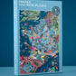 Die farbenfrohe Schachtel des Water & Wines - Wein Puzzle - Frankreich (1000 Teile) steht aufrecht vor einem blauen Hintergrund und zeigt eine lebendig illustrierte Karte der französischen Weinregionen sowie den Markennamen Water & Wines auf dem Deckel.