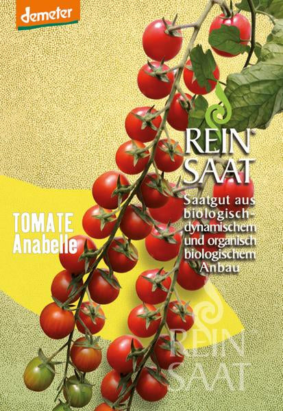 Auf einer Samenpackung mit der Aufschrift „Reinsaat – Tomate ‚Anabelle‘“ ist eine Traube reifer Kirschtomaten am Strauch abgebildet, die mit Bio-Siegeln und deutschem Text versehen ist.