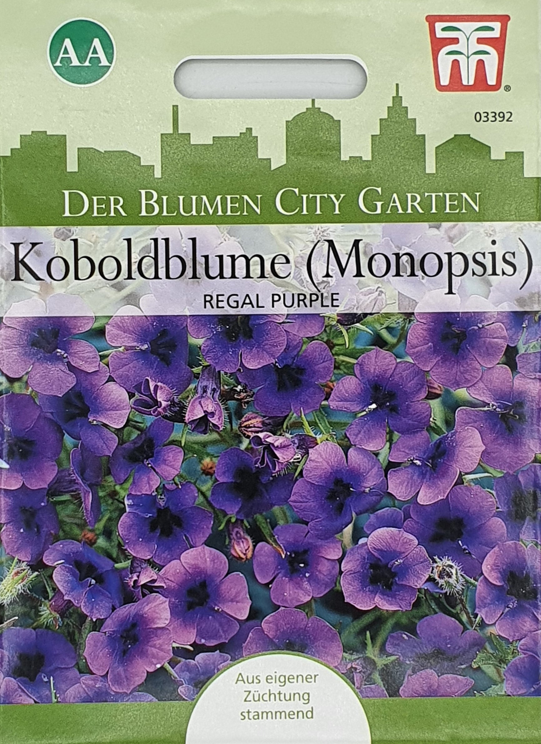 Eine Thompson und Morgan Samenpackung mit der Aufschrift Koboldblume (Monopsis) Regal Purple zeigt Büschel von kleinen, mitternachtsblauen Blüten mit einer grünen Stadtsilhouette und deutschem Text. Ideal für städtische Gärten, Hängekörbe; Einjährige.