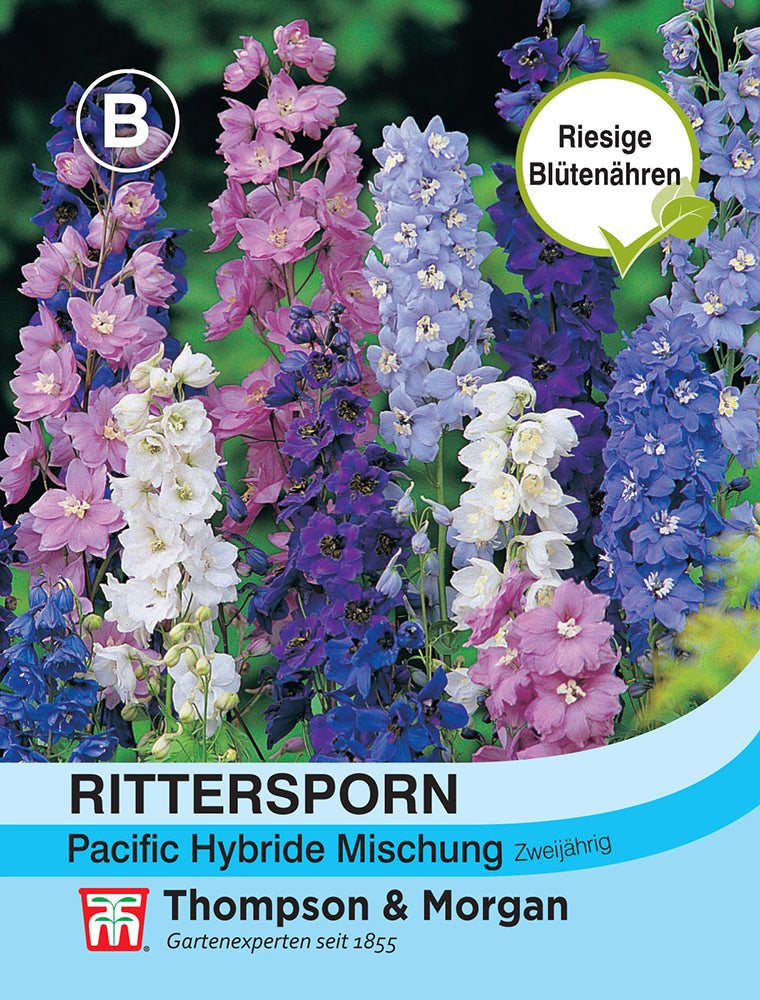 Samenpackung von Rittersporn Pacific Hybride Mischung von Thompson und Morgan, mit hohen Rispen mit rosa, lila, weißen und blauen Blüten. Die Packung hebt "Riesige Blütenähren" hervor und bietet eine atemberaubende Mischung von Rittersporn.